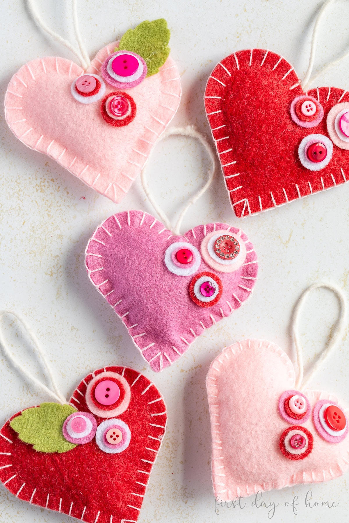 Felt heart ornaments with button flower accents.
