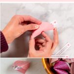 Hand forming a paper fortune cookie and finished fortune cookies made from colorful scrapbook paper.