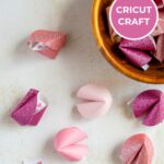 Paper fortune cookies with printed fortune messages.