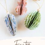 Paper honeycomb Easter ornaments in the shapes of bunnies, carrots, and eggs.
