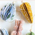 Paper honeycomb Easter ornaments in the shapes of bunnies, carrots, and eggs.