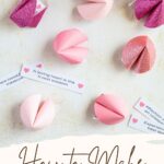 Paper fortune cookies with paper fortunes around them.