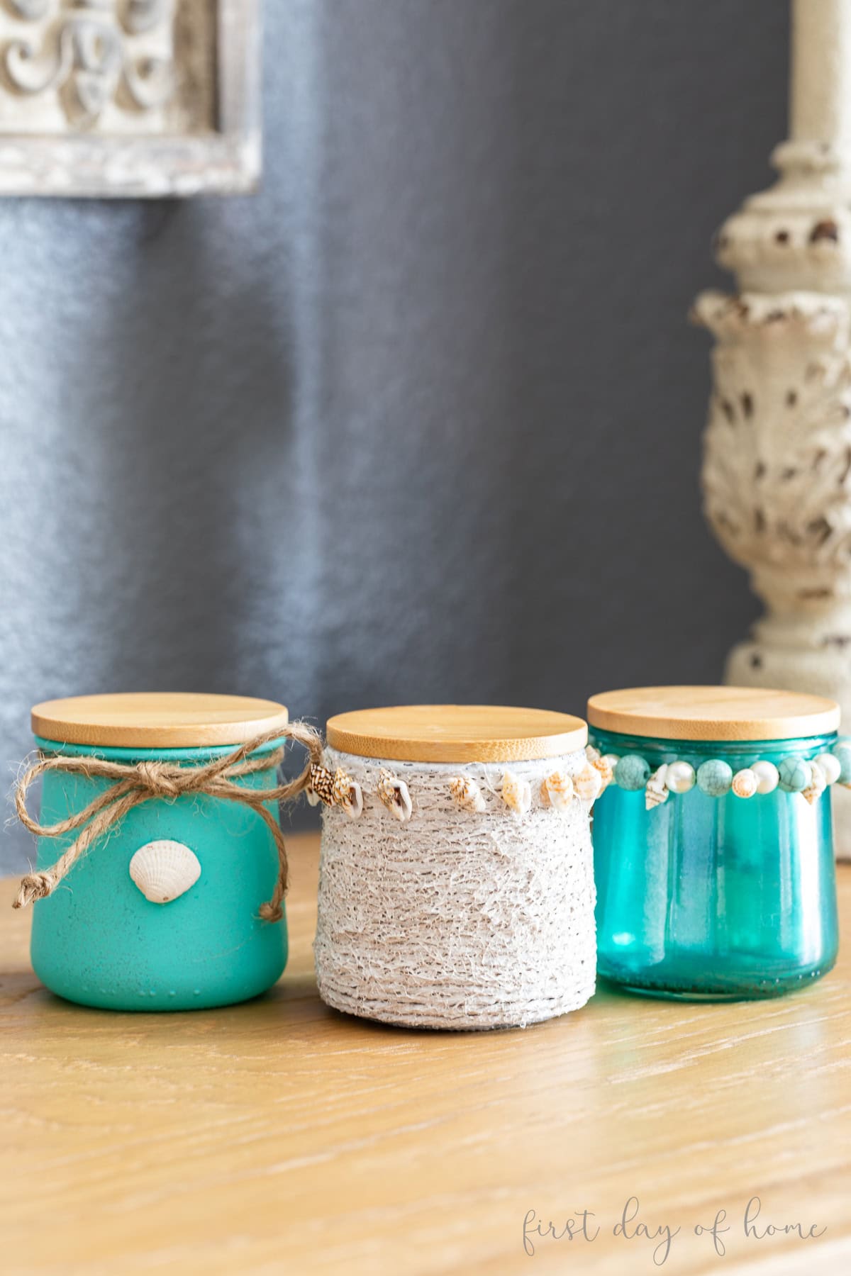 Three glass Oui yogurt jars painted and decorated with Mod Podge and paint.
