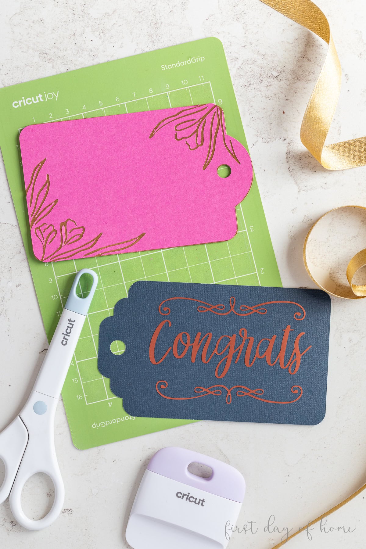 Cricut gift tags with layered paper and foil adhesive vinyl, shown with Cricut mat and tools.