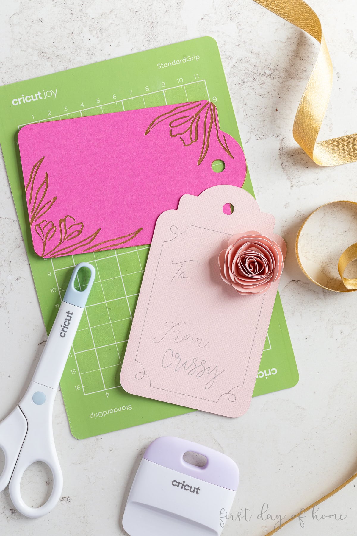 Two Cricut gift tags with a layered design and paper flower design.