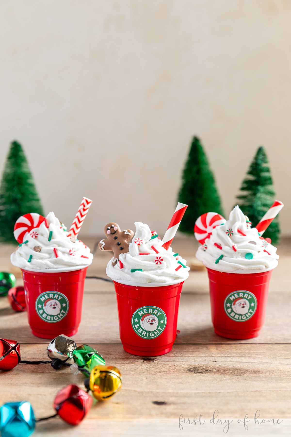 Three mini coffee cup ornaments that look like Starbucks coffees.